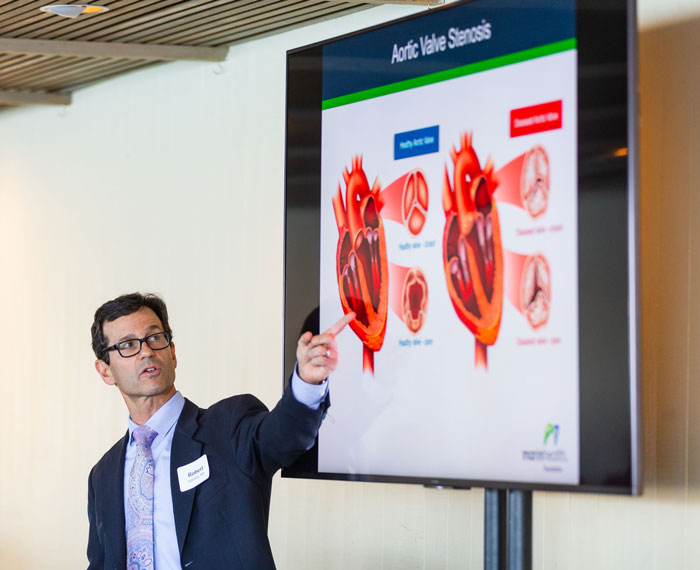 presenter pointing at screen presentation